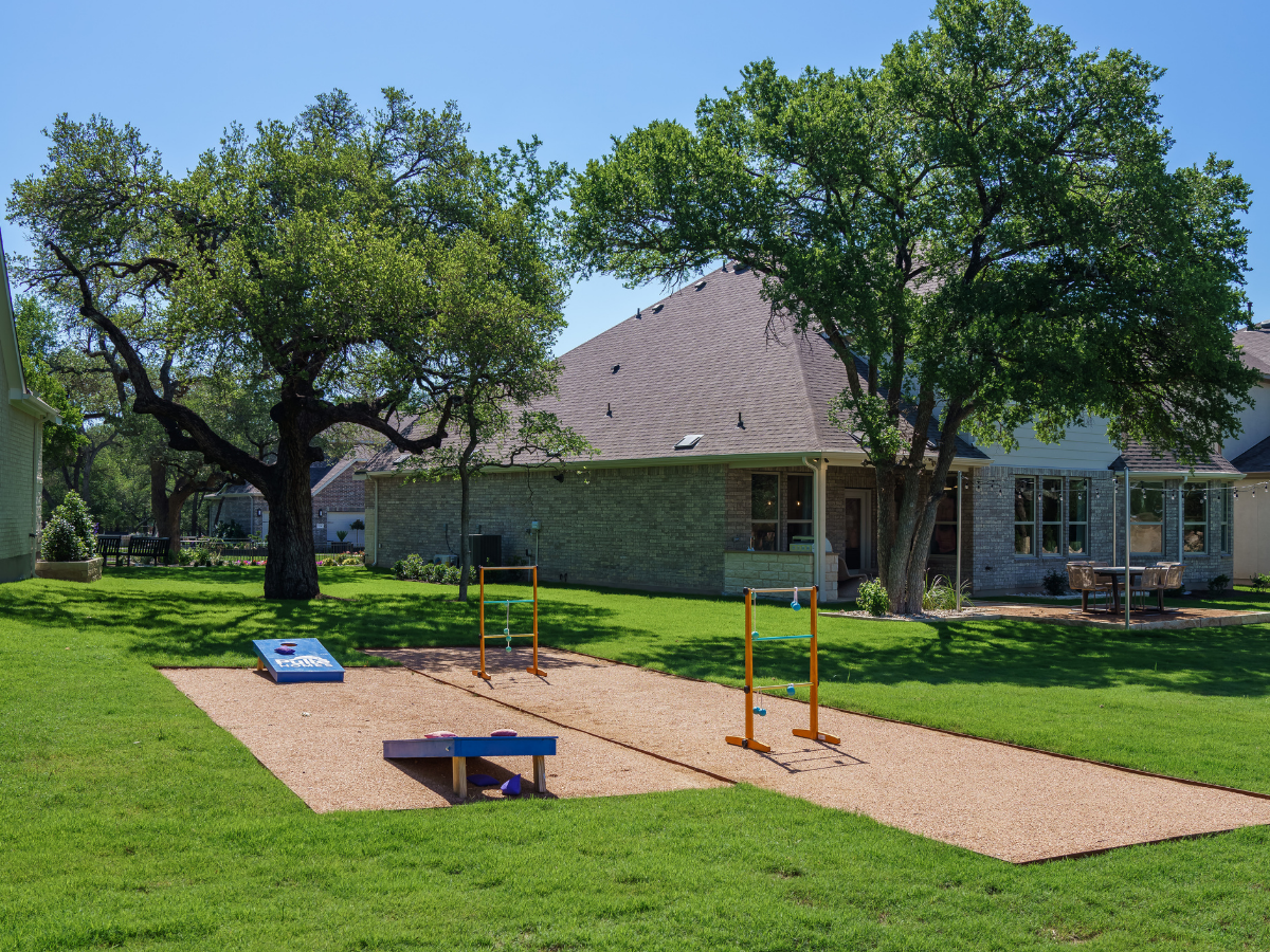 cornhole in backyard model home staging