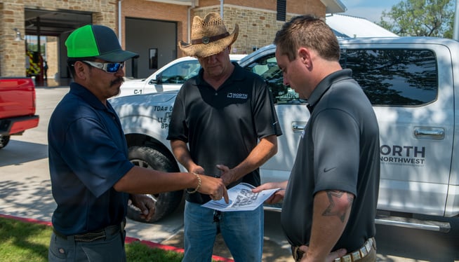 commercial landscaping crew reviewing design plan