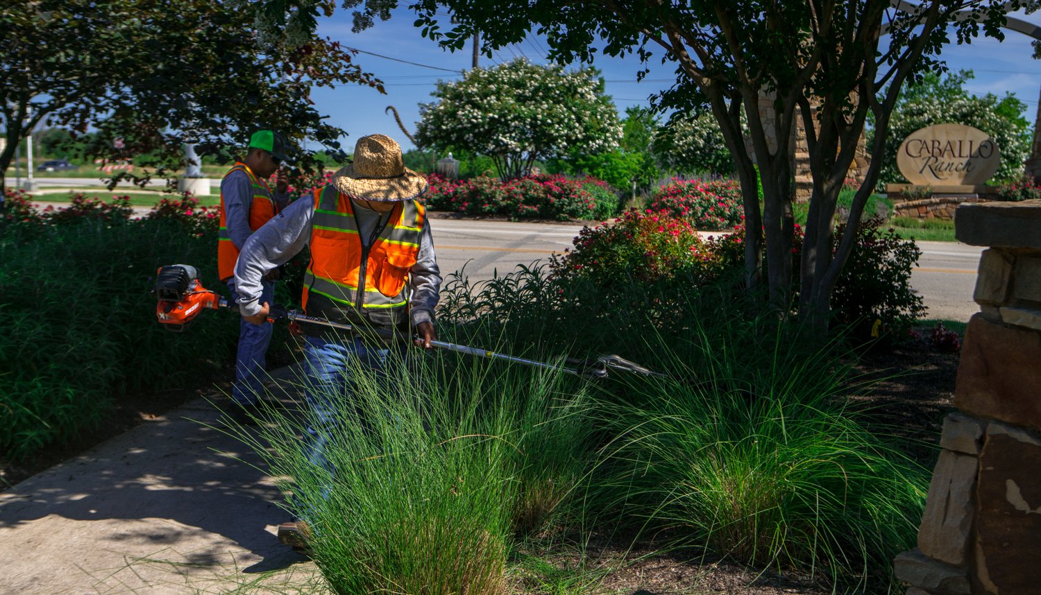 commercial landscapers maintaining HOA property