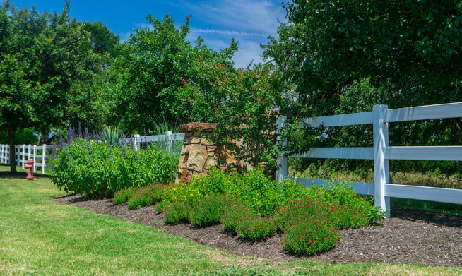 healthy plants and shrubs around apartment complex sign