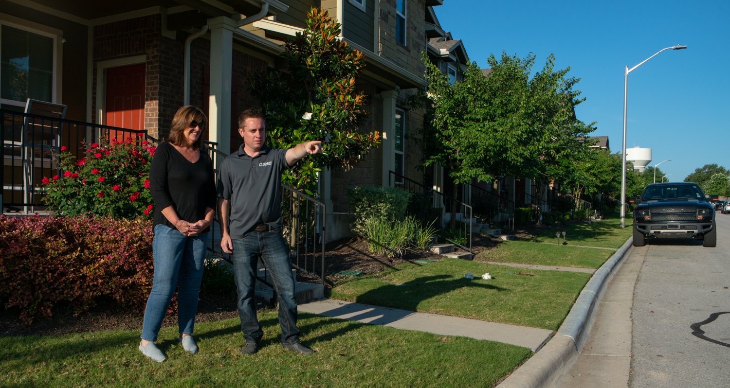 Landscape maintenance crew speaking with HOA customer