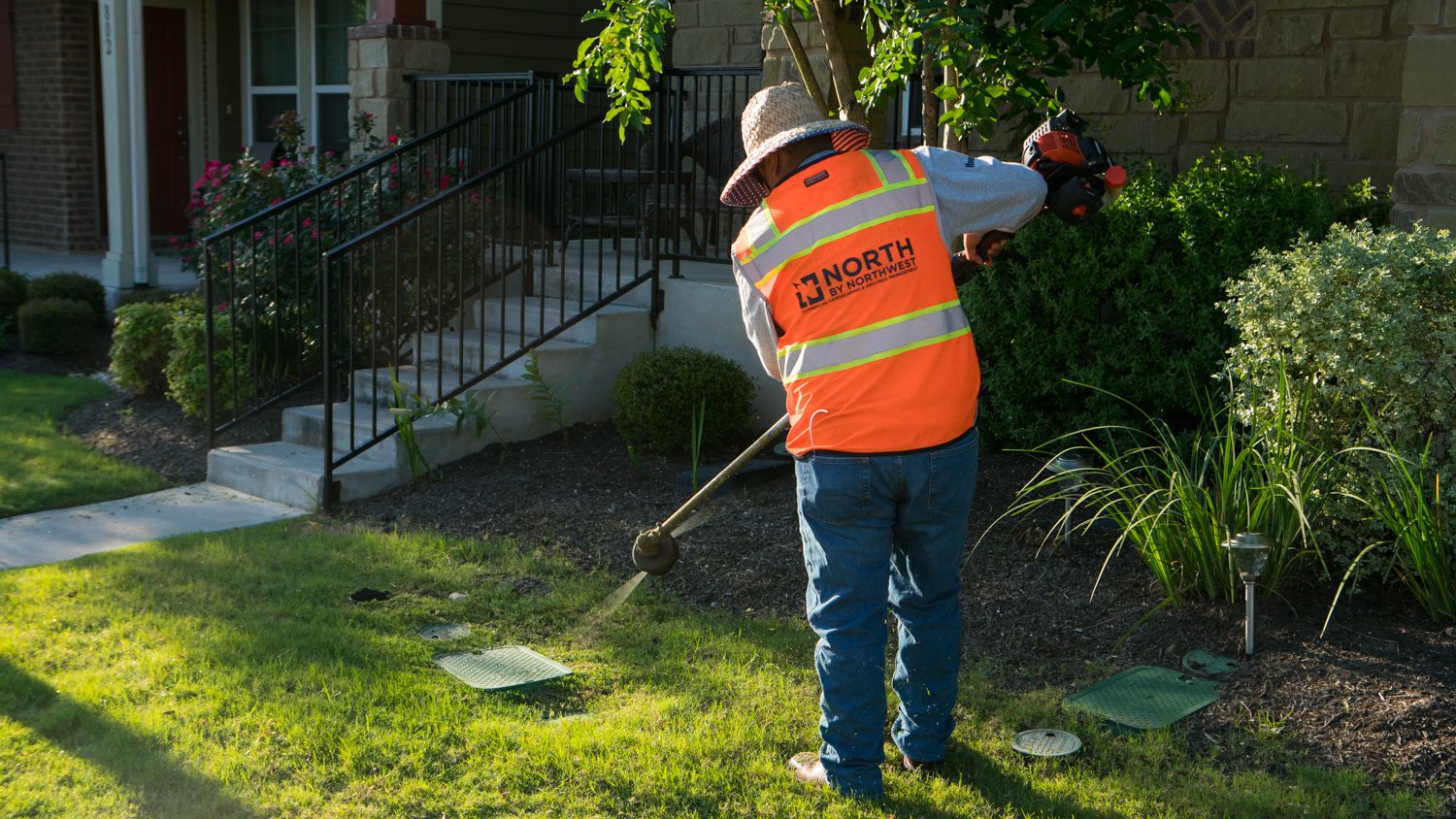 North by Northwest commercial landscaping employee trimming