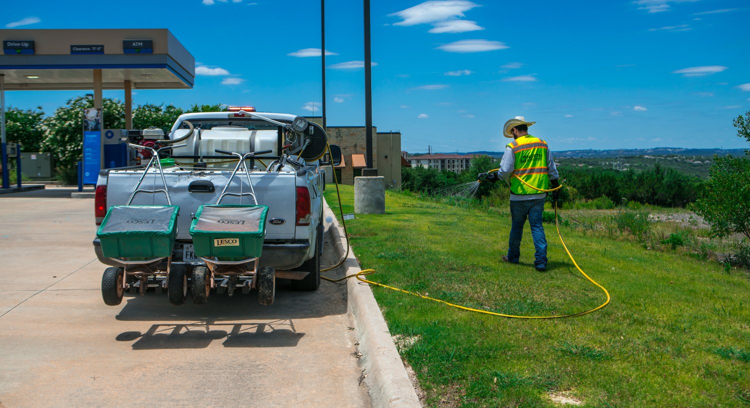 Maintenance crew spraying weed control at Chase Bank