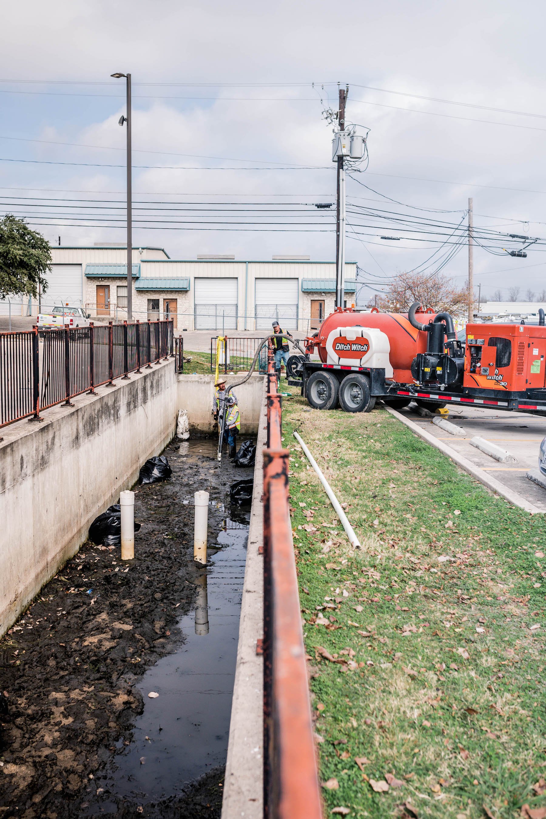 landscapers repairing detention basin in Austin, TX