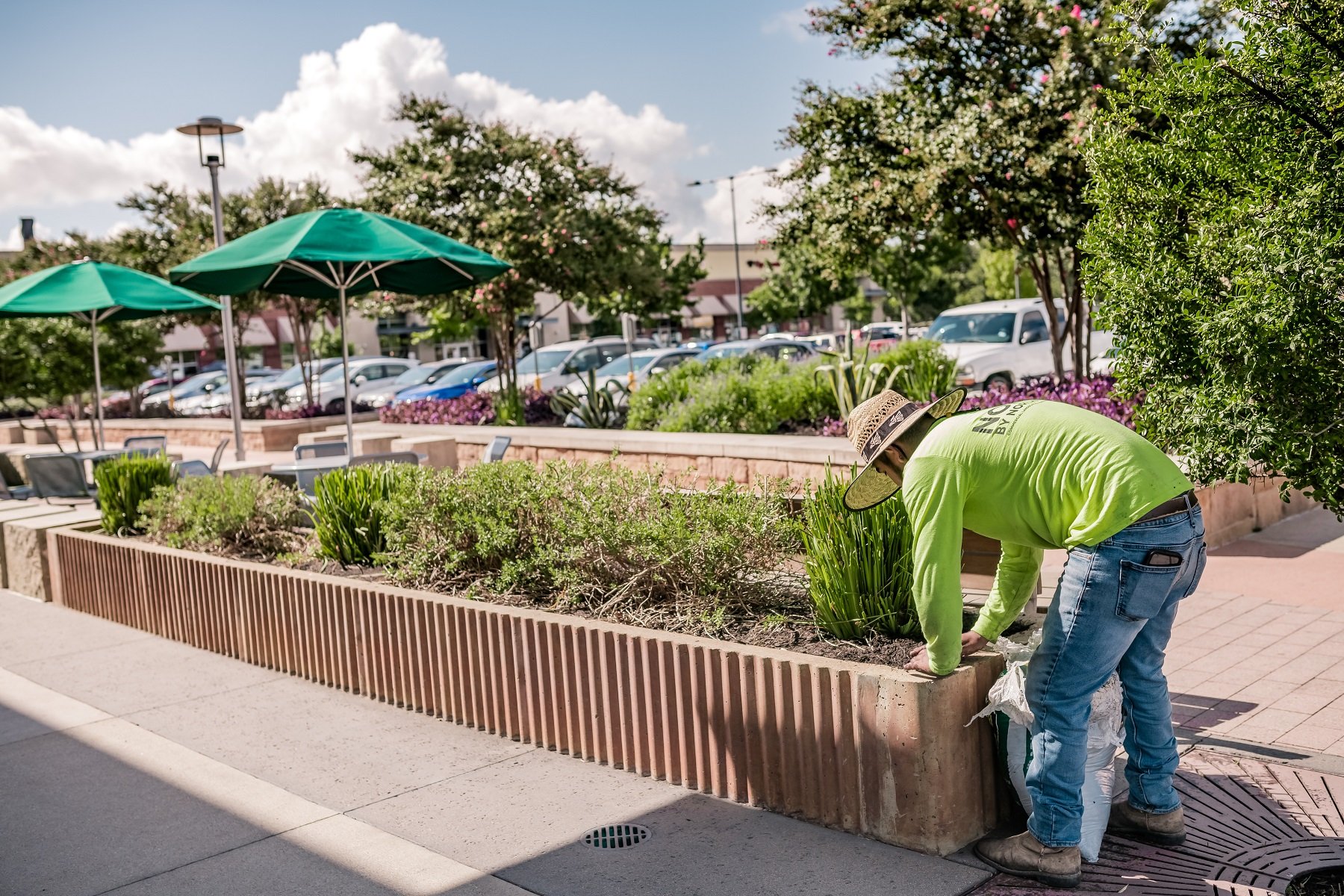 Maintenance team taking care of shopping center planting beds