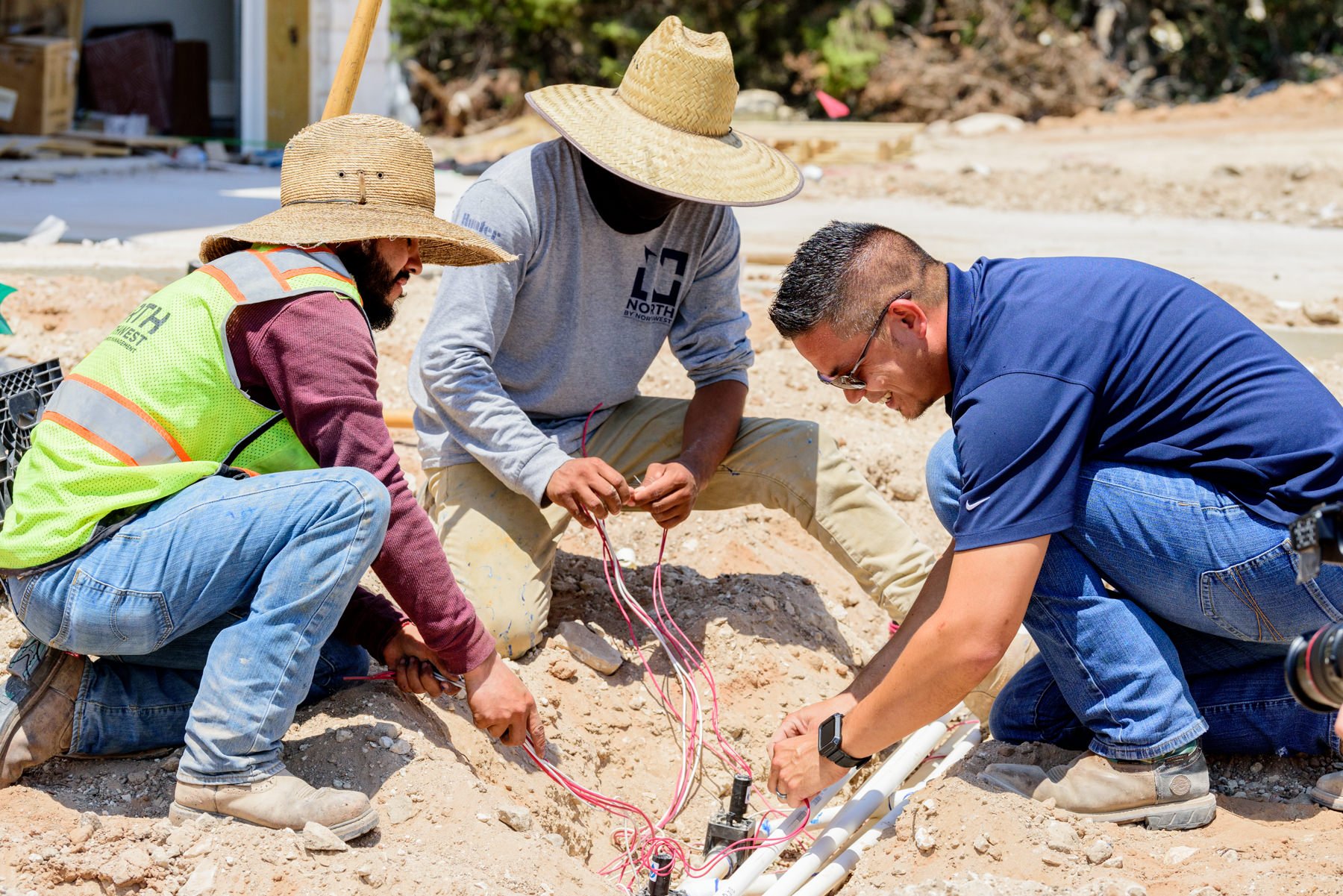 Irrigation team installing irrigation valves and wiring